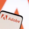 Adobe logo is seen on smartphone in this illustration taken June 13, 2022. REUTERS/Dado Ruvic/Illustration//File Photo