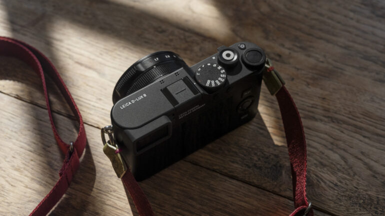 Top view of the Leica D-Lux 8 compact camera on wooden surface