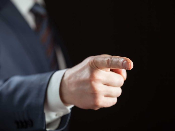 Person pointing with finger, wearing a suit