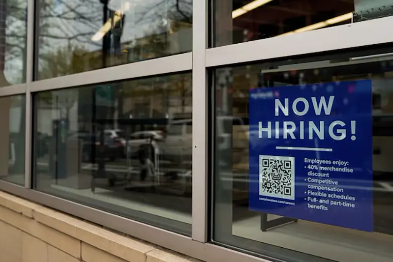 An employee hiring sign with a QR code is seen in a window of a business in Arlington, Virginia, U.S., April 7, 2023. REUTERS/Elizabeth Frantz/ File Photo