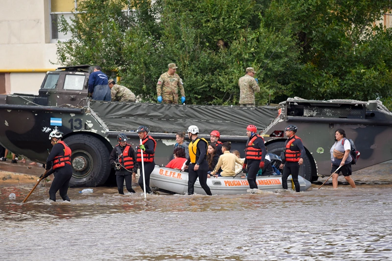 People is transported on a police boat through flooded waters the day after a heavy storm in Bahia Blanca, 600 km south of Buenos Aires on March 8, 2025. At least ten people died and more than 1,000 were evacuated in the Argentine port city of Bahia Blanca as torrential rains flooded homes and hospitals, destroyed roads and forced authorities to cut the power. (Photo by PABLO PRESTI / AFP) (Photo by PABLO PRESTI/AFP via Getty Images)