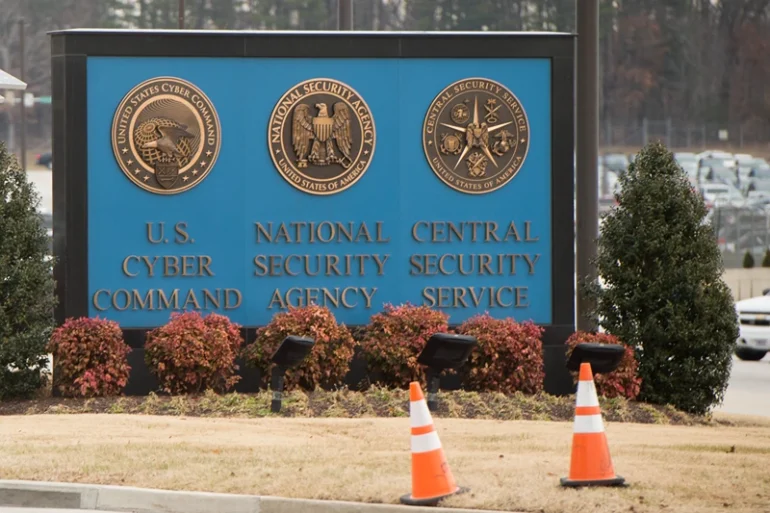 A sign for the National Security Agency (NSA), US Cyber Command and Central Security Service, is seen near the visitor's entrance to the headquarters of the National Security Agency (NSA) after a shooting incident at the entrance in Fort Meade, Maryland, February 14, 2018. Shots were fired early Wednesday at the ultra-secret National Security Agency, the US electronic spying agency outside Washington, leaving one person injured, officials said. Aerial footage of the scene from NBC News showed a black SUV with numerous bullet holes in its windshield crashed into concrete barriers at the main entrance to the NSA's headquarters in Fort Meade, Maryland. (Photo by SAUL LOEB / AFP) (Photo by SAUL LOEB/AFP via Getty Images)