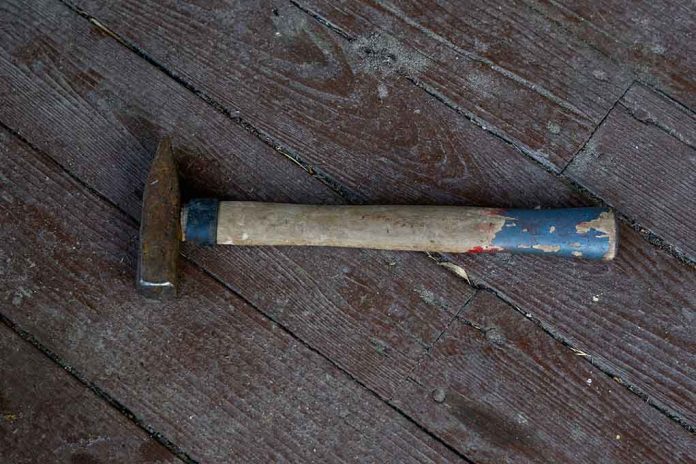 Rusty hammer on a worn wooden floor.