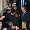 3-year-old cancer survivor Devarjaye "DJ" Daniel is lifted up by his father Theodis Daniel after given credentials from US Secret Service Director Sean Curran after US President Donald Trump made him an honorary member of the US Secret Service during his address to a joint session of Congress at the US Capitol in Washington, DC, on March 4, 2025. (Photo by SAUL LOEB / AFP) (Photo by SAUL LOEB/AFP via Getty Images)