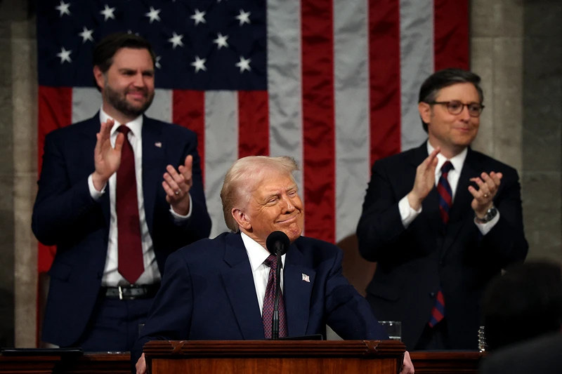 Vice President JD Vance and Speaker of the House Mike Johnson (R-LA) applaud as US President Donald Trump looks to the guests during his address to a joint session of Congress at the US Capitol in Washington, DC, on March 4, 2025. (Photo by Win McNamee / POOL / AFP) (Photo by WIN MCNAMEE/POOL/AFP via Getty Images)