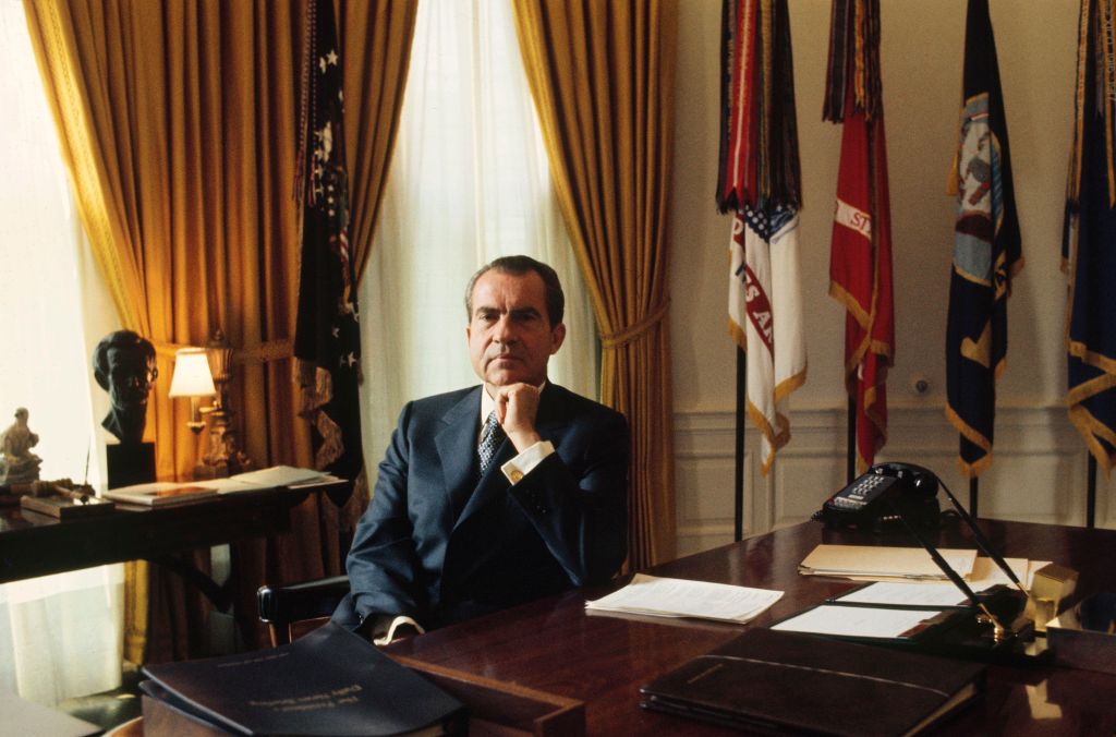 Richard Nixon sitting in the Oval Office during the 1970s