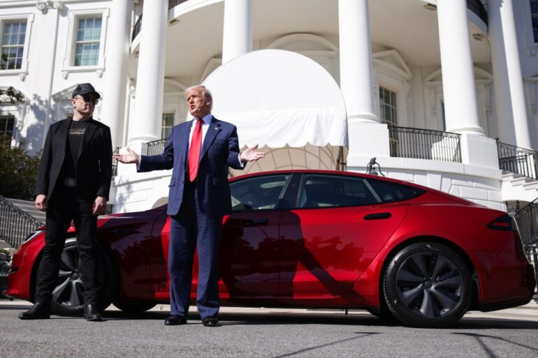 Elon Musk and President Trump stand next to a Tesla at the White House.