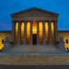 Illuminated courthouse building at dusk with columns