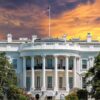 White House with sunset sky background and flag