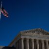 The US Supreme Court building in Washington, DC, with a flag pole in the foreground, linked to legal challenges on a military ban for transgender troops.