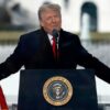 Trump speaking at a podium with microphones