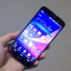 A hand holding the LG G Flex phone
