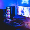 Young gamer playing online platform with neon lights in background
