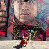 Sunset Park Yorkie Louie is dressing as rapper LL Cool J in a red shirt red hat and large gold chain
