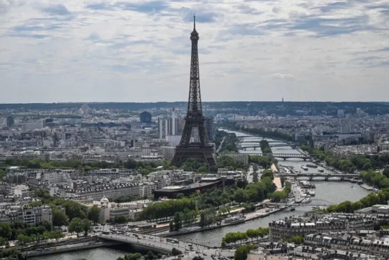 This photograph taken onboard a helicopter shows a view of the Seine river and the Eiffel Tower during a rehearsal, three days ahead of the Bastille Day parade, in Paris on July 11, 2023. (Photo by Emmanuel DUNAND / AFP) (Photo by EMMANUEL DUNAND/AFP via Getty Images)