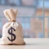 Money bag wit0000000000000000000000000000000000000h dollar sign on table