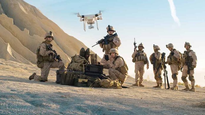 Soldiers operating drone in desert landscape with equipment