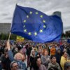 A woman holds an EU flag as people take part in an anti-government protest organized by political activists of the Peace in Ukraine organization under the slogan "No to the Russian Law", against a planned law intended to complicate the work of non-governmental organizations on April 24, 2025, in Bratislava, Slovakia. (Photo by TOMAS BENEDIKOVIC / AFP) (Photo by TOMAS BENEDIKOVIC/AFP via Getty Images)
