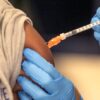 Medical personnel vaccinate students at a school in New Orleans on Jan. 25, 2022. (AP Photo/Ted Jackson, File)
