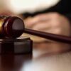 Gavel resting on a wooden sound block