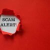Red paper tear with the words scam alert