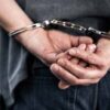 Person in handcuffs with hands behind back