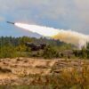 Military tank firing a missile in forest area