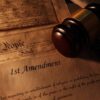 First Amendment document with gavel and Constitution background
