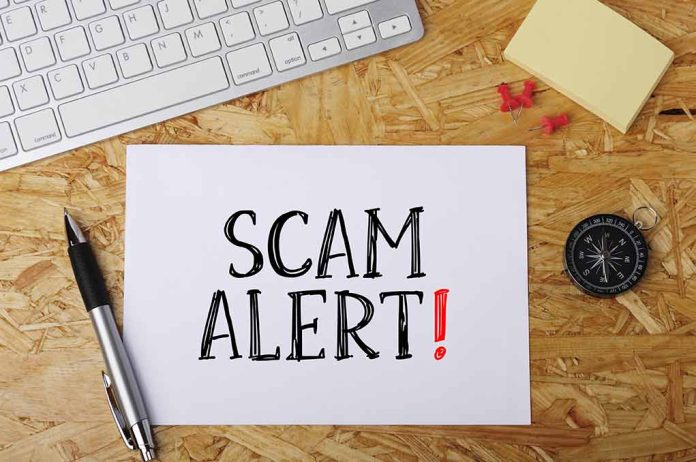 Scam alert message on a wooden desk.
