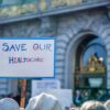 Sign reading Save Our Healthcare at protest