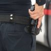 Person holding a gun in a holster