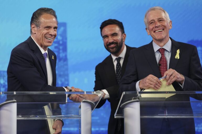 Democratic mayoral candidates Andrew Cuomo, left, shakes hands with Zohran Mamdani, center, as Whitney Tilson reacts after participating in a Democratic mayoral primary debate, Wednesday, June 4, 2025, in New York.