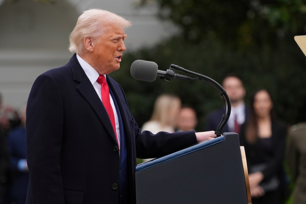 Donald Trump speaking at a podium.