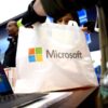 A person holding a Microsoft shopping bag.