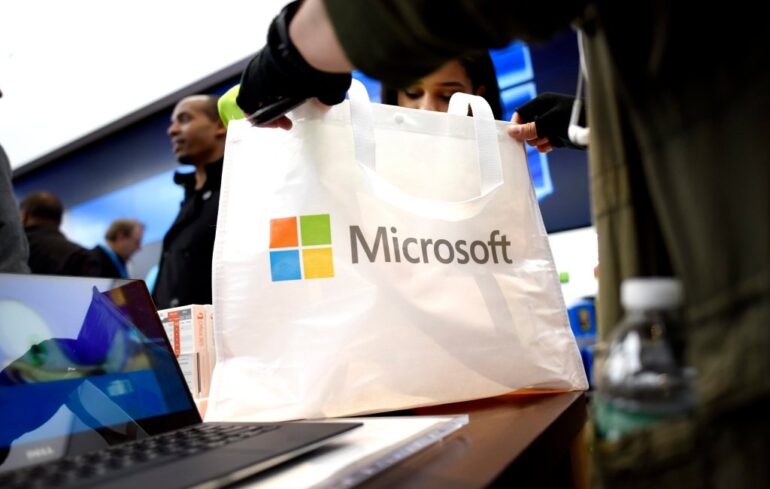 A person holding a Microsoft shopping bag.