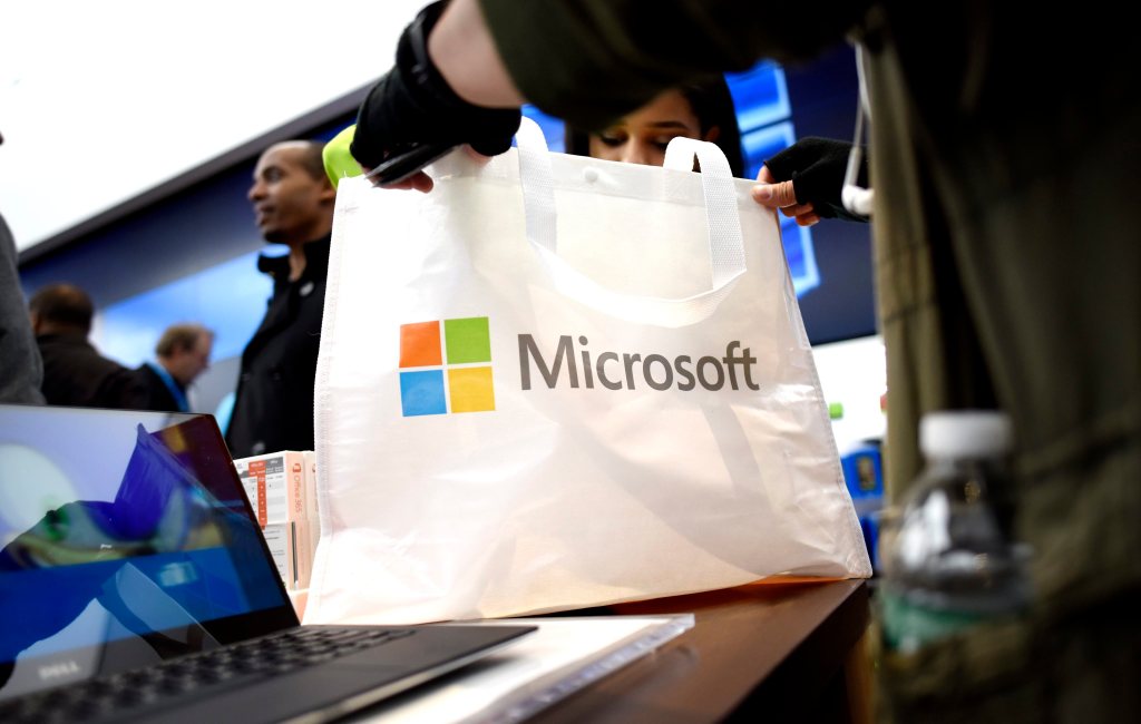 A person holding a Microsoft shopping bag.