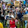 People gather June 6 on the National Mall in Washington, D.C., at the Unite for Veterans, Unite for America Rally to support veterans' rights and oppose policies of President Donald Trump.