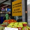 People shop for food at a store in New York City that advertises that it accepts SNAP benefits, also known as food stamps. The Brooklyn neighborhood has a large immigrant and elderly population.