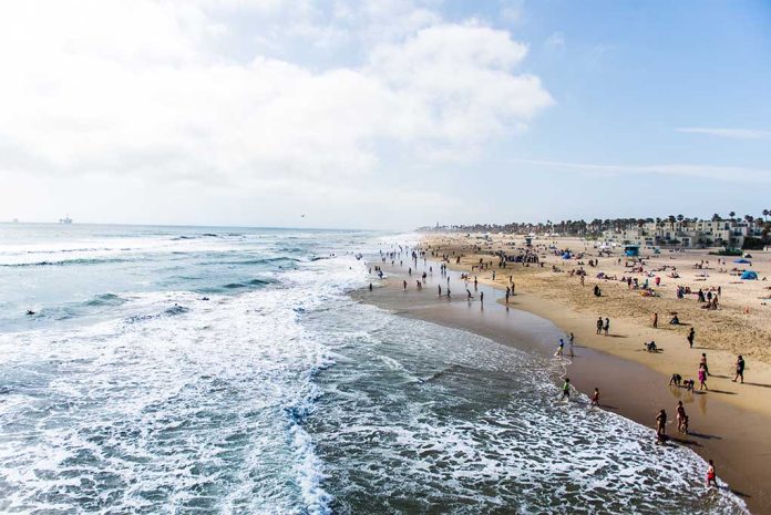 Crowded beach with waves and people enjoying sun