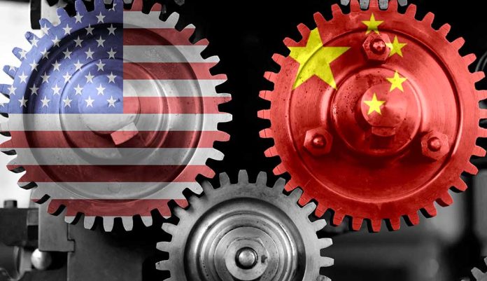 Interlocking gears with USA and China flags