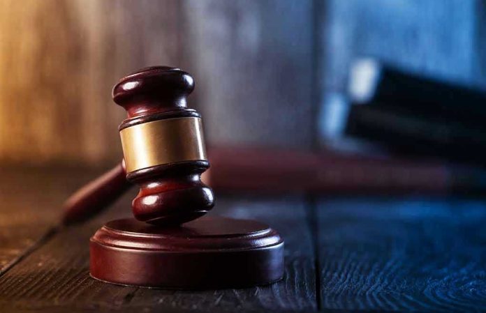 Gavel on wooden table in dimly lit room