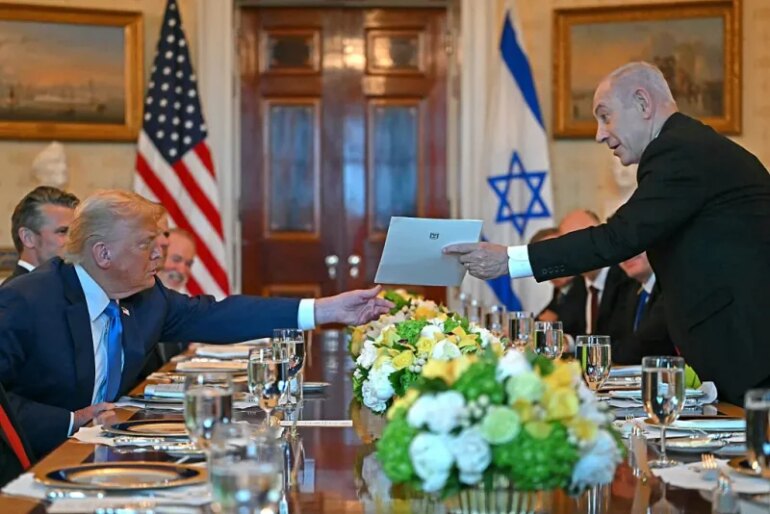 Israeli Prime Minister Benjamin Netanyahu (R) hands over a letter to US President Donald Trump as they meets at the Blue Room of the White House in Washington, DC, on July 7, 2025. Prime Minister Netanyahu will meet Monday with President Trump, who expressed hope for a "deal this week" between Israel and Hamas that sees hostages released from the Gaza Strip. Indirect negotiations between Israel and Hamas began on July 6 in Doha, aiming to broker a ceasefire and reach an agreement on the release of hostages in exchange for Palestinian prisoners. (Photo by ANDREW CABALLERO-REYNOLDS / AFP) (Photo by ANDREW CABALLERO-REYNOLDS/AFP via Getty Images)