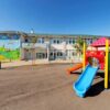 Colorful playground slide in front of a building