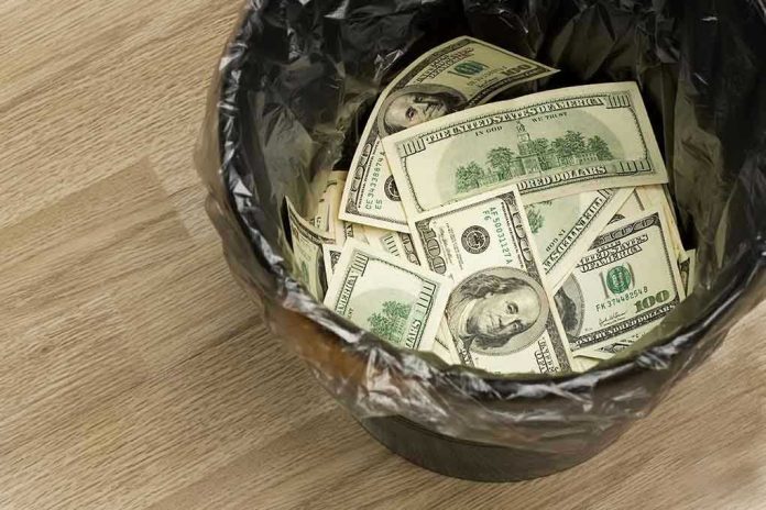 Trash bin filled with one hundred dollar bills