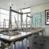 Empty classroom with chairs on top of desks