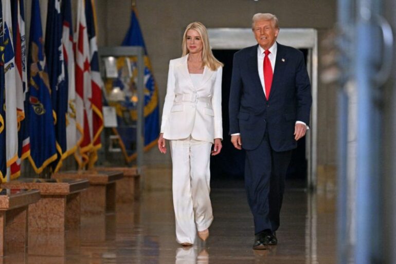US President Donald Trump and US Attorney General Pam Bondi (L) arrive to speak at the Department of Justice in Washington, DC, on March 14, 2025. (Photo by ROBERTO SCHMIDT / AFP) (Photo by ROBERTO SCHMIDT/AFP via Getty Images)