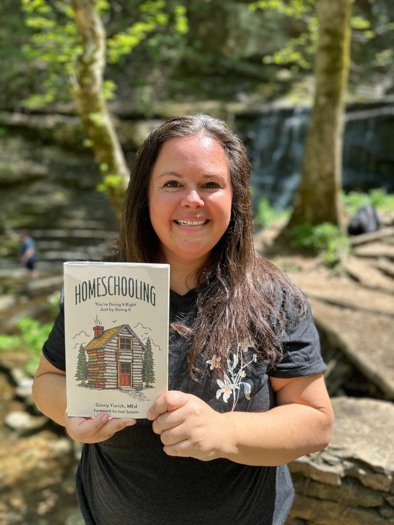 Ginny Yurich holding her book, Homeschooling: You're Doing It Right Just by Doing It.