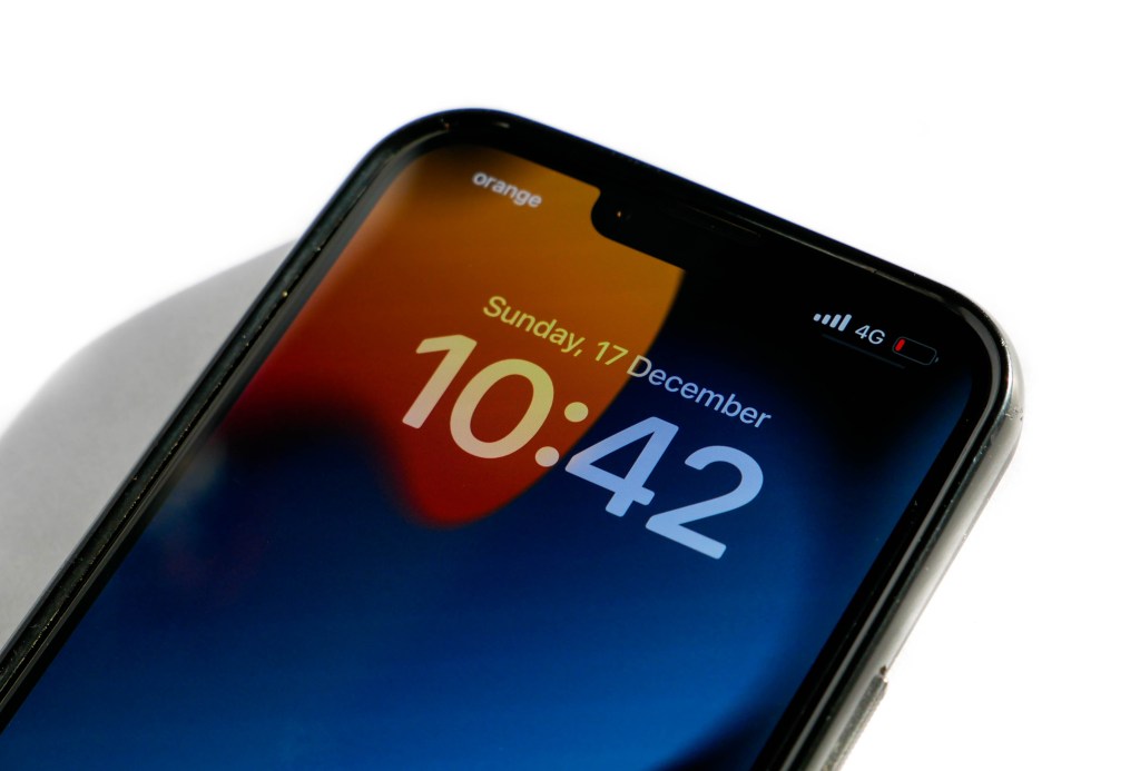 Close-up of an iPhone 13 Pro Max displaying low battery.