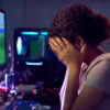 Upset gamer with her head in her hands
