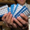 Former Manila Health Secretary Manuel Dayrit shows packs of "family planning pills" being prepared for distribution in Manila as part of $3.5 million assistance from the USAID and the U.N. Population Fund in 2004.